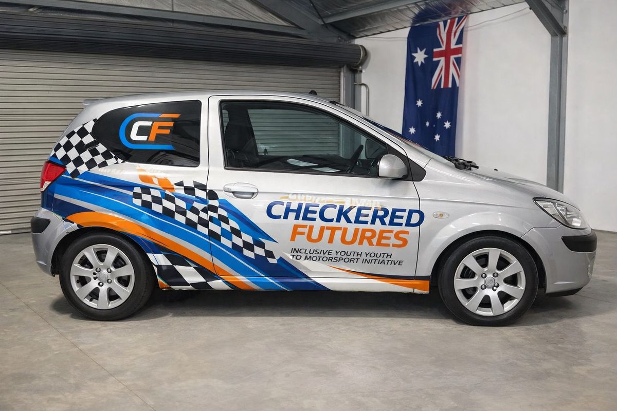The Checkered Futures Hyundai Getz in full team livery, chequered flag and sponsor graphics along its side.